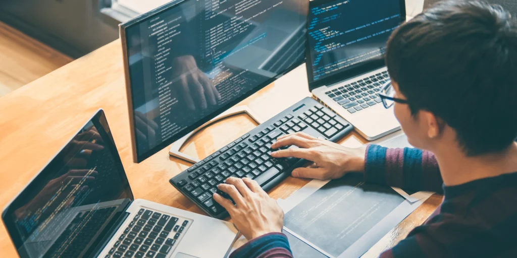 Man typing code on his computer to optimize page speed